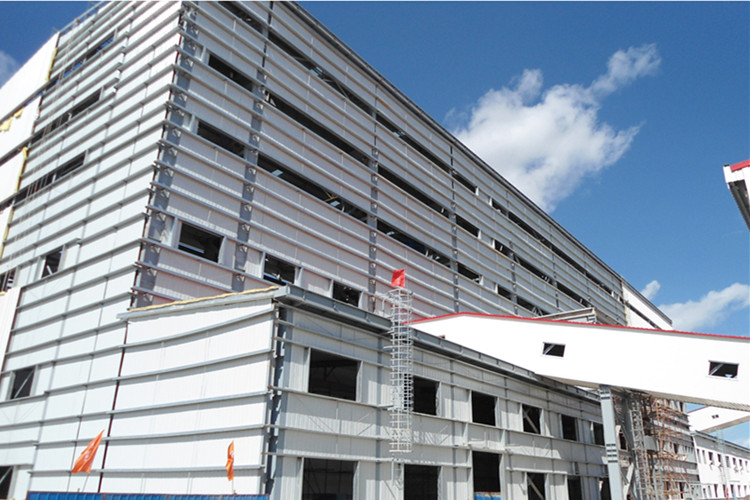 Exterior view of a high rise metal frame steel building designed for heavy industrial workshop use