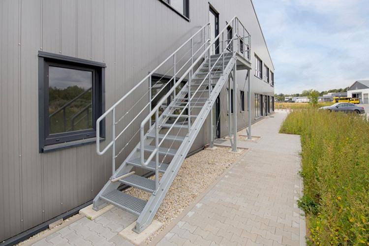 Industrial steel stairs and sectional door integration in prefabricated buildings