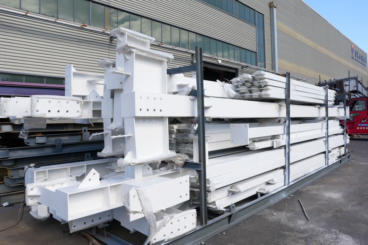 Securely bundled primary steel frame components ready for transport